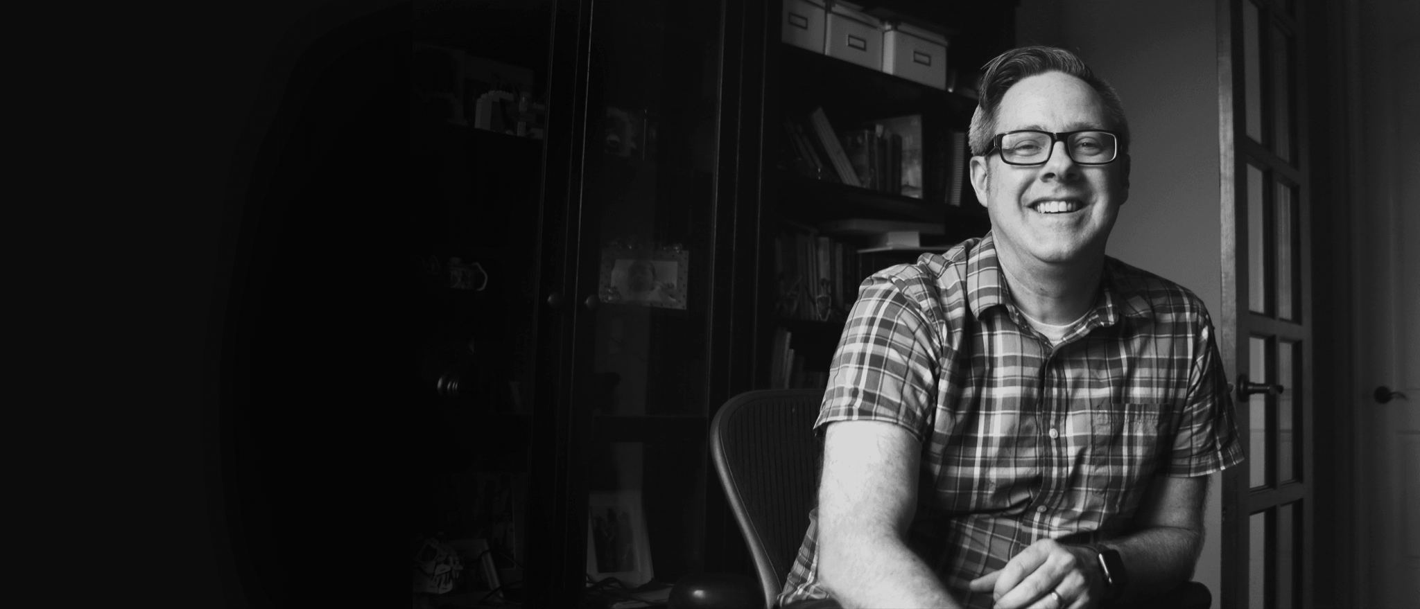 Brent Dykes, smiling, seated in his office